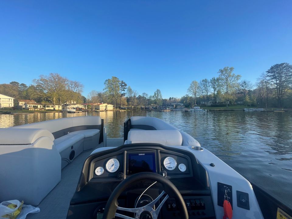 Bentley Navigator 243 helm, gauges and steering wheel, looking out over the lake